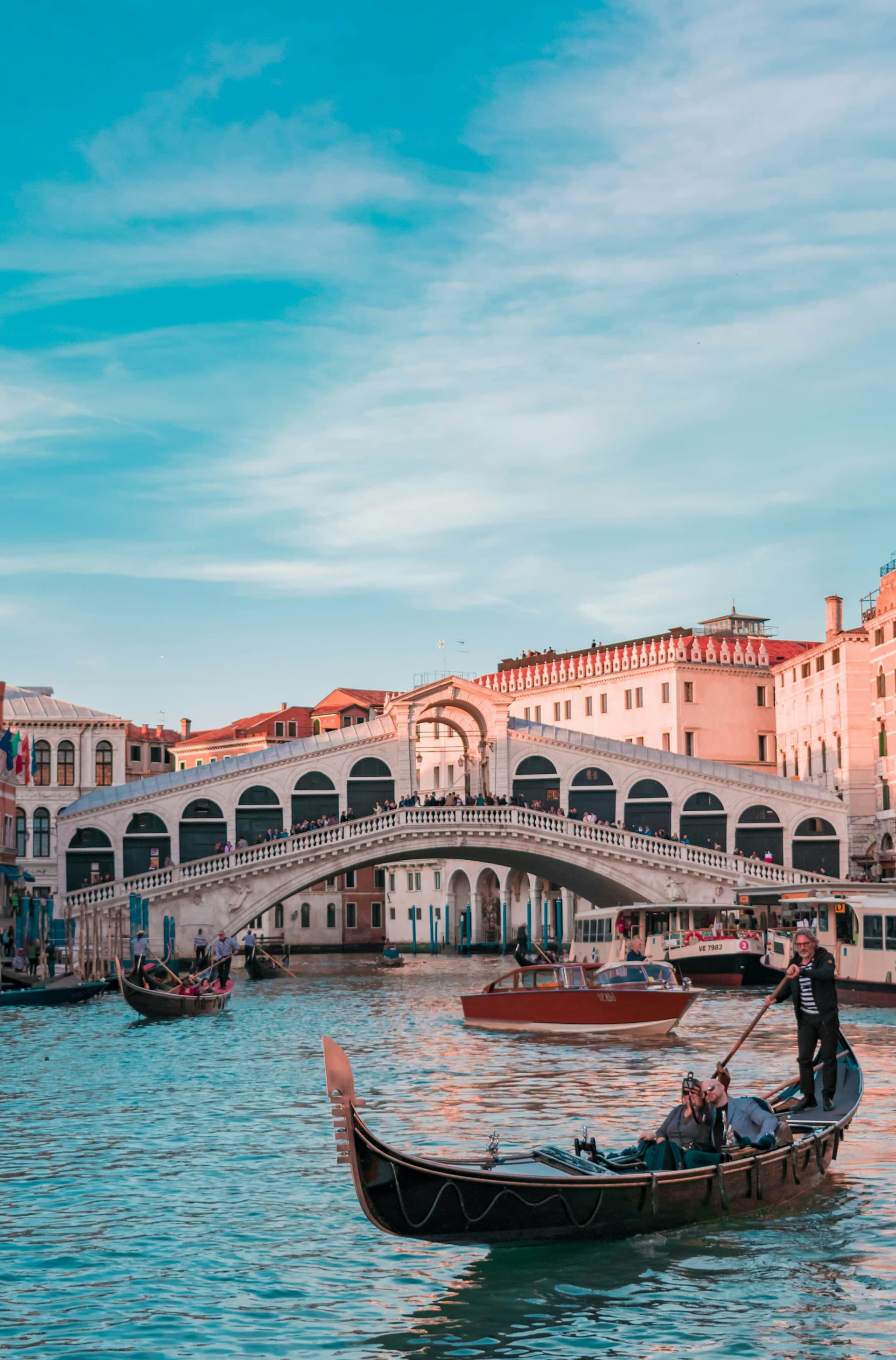 Venice canal at sunset with gondolas
